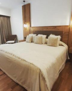 a bedroom with a large bed with white sheets and pillows at Noha Casa de Campo in Colón