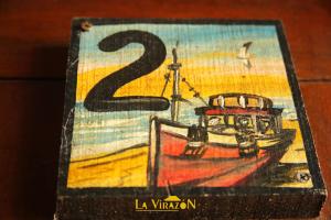 a painting of a boat with the number two at La Virazón in Punta Del Diablo