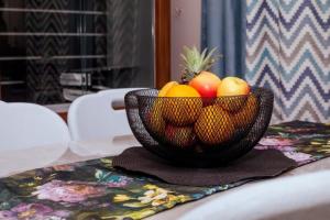 a bowl of fruit sitting on top of a table at Birdville BNB Guest House in Gaborone