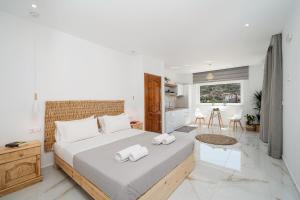 a bedroom with a large bed with towels on it at Amalia in Matala