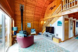 a large living room with a television and a living room with a staircase at Hallie Hideaway (MCA #329) in Manzanita