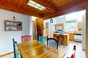 a kitchen and dining room with a wooden table and chairs at Hallie Hideaway (MCA #329) in Manzanita