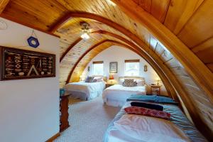 a room with two beds and an arched ceiling at Hallie Hideaway (MCA #329) in Manzanita
