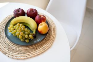 a plate of fruit on a table at Amalia in Matala
