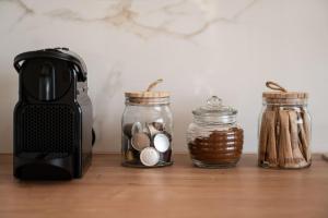 a counter with jars of money and a coffee maker at Amalia in Matala