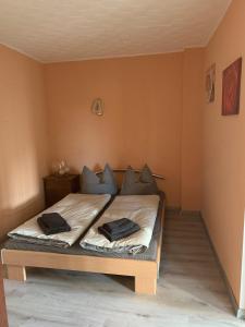 a bedroom with a bed with two pillows on it at Ferien-Landleben in Löbnitz