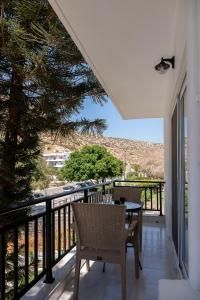 a patio with a table and chairs on a balcony at Amalia in Matala