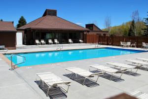 a group of lounge chairs and a swimming pool at Three Kings by White Pines in Park City