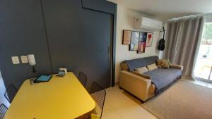 a living room with a yellow table and a couch at Riviera Beach Place - Aquiraz Riviera in Fortaleza +57 photos