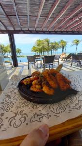 a plate of food sitting on top of a table at Riviera Beach Place - Aquiraz Riviera in Fortaleza