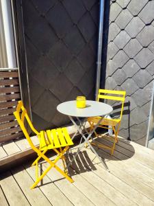 a table and two chairs sitting on a porch at Le cosy 40 - maison typique au centre de Malmedy in Malmedy