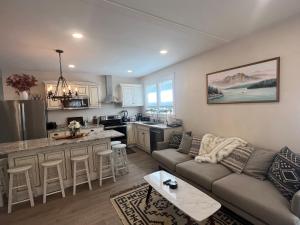 a living room with a couch and a kitchen at The Reminisce vacation home 5br/3bt,downtown BH in Bar Harbor