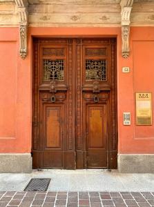 a large wooden door on the side of a building at B&B Volta in Como