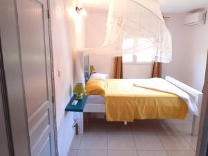 a small room with two beds and a window at Chez coco appartement AZURE in Petit Bourg