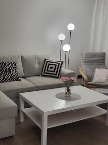 a living room with a couch and a coffee table at BAM apartments in Palanga