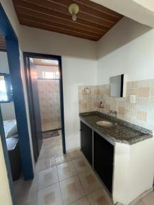 a bathroom with a sink and a counter top at Chalés de Triunfo in Triunfo +134 photos