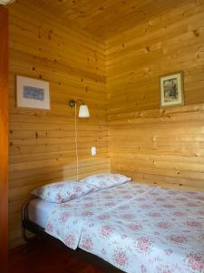 a bedroom with a bed in a wooden room at Apartments Bulatovic in Žabljak