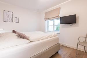 En eller flere senge i et værelse på Landhaus Hygge