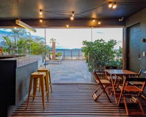 a patio with tables and chairs and a view of the ocean at B&B HOTEL Rio Copacabana Posto 5 in Rio de Janeiro