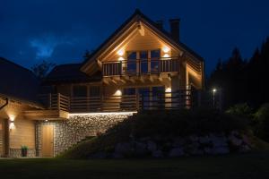 a house lit up at night with lights at Chalet Camporosso in Camporosso in Valcanale