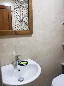 W łazience znajduje się biała umywalka i lustro. w obiekcie relax w mieście Samtredia