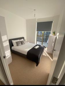 a bedroom with a bed and a large window at The Perfect inn in London