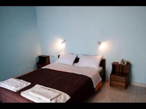 una camera da letto con un grande letto con due comodini di Room in BB - The Quality And Hospitalityof Apraos Bay Hotel Has Been Identified ad Apraos