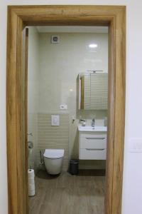 a bathroom with a tub and a toilet and a sink at Apartman IM7 Međugorje in Međugorje