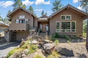 a house in the woods with a driveway at Luxury on Lassen in Sunriver