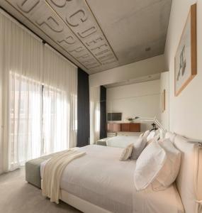 Un ou plusieurs lits dans un hébergement de l'établissement Hotel Tipografia do Conto by Casa do Conto