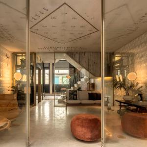 a lobby of a building with glass walls at Hotel Tipografia do Conto by Casa do Conto in Porto