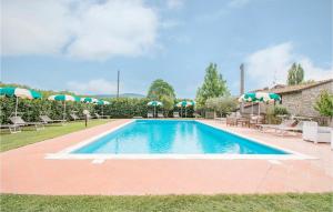 a pool with chairs and umbrellas in a yard at Awesome Apartment In Magione With Wifi in Magione +19 photos