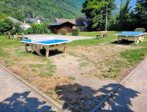 two ping pong tables sitting in a park at Appartement T3 dans résidence 6 pers in Juzet-de-Luchon