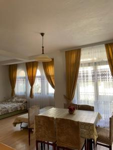 a living room with a table and chairs and a bed at Guest House Ohrid Trpeski in Ohrid