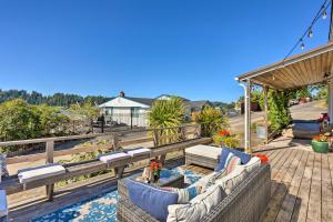 a patio with two couches on a wooden deck at Gig Harbor House with Private Beach and Views! in Gig Harbor