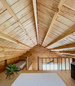 a room with a wooden ceiling with a potted plant at Mountain Eco Shelter 3 in Corujeira de Dentro