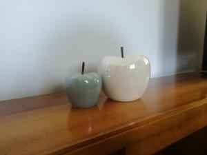 two white vases sitting on top of a wooden table at MAISON BLANC in Aymavilles