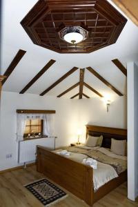 a bedroom with two beds and a ceiling with beams at The House of the Miyaks in Rostuša