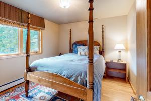 a bedroom with a four poster bed and a window at Kobza's Quandary View in Breckenridge
