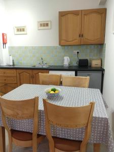 a kitchen with a table with a bowl of fruit on it at Town centre one bed apartment in Dungarvan