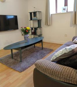 a living room with a table and a couch at Town centre one bed apartment in Dungarvan
