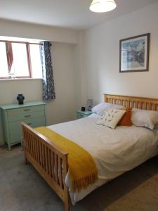 a bedroom with a large bed and two windows at Town centre one bed apartment in Dungarvan