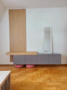 a dressing room with a table and a mirror at Cozy studio apartment at center of Bijeljina in Bijeljina +9 photos