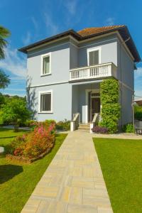 une maison blanche avec un chemin devant elle dans l'établissement Villa Moiacchina Luxury Home, à Bevera