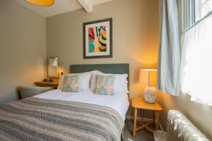 a small bedroom with a bed and a window at The Rose & Crown, Ashbury in Ashbury