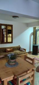 a living room with a table and a couch at SVETLA U PLANINI in Bajina Bašta