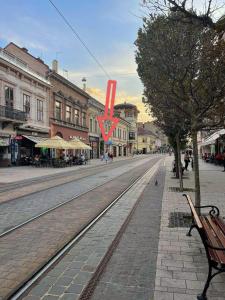 an empty street with a red kite in a town at Fit Paradise Apartman in Miskolc +6 photos