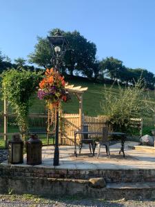 a park bench and a street light with a lamp at Molehill lodge in Swansea