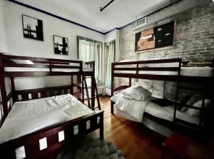 a bedroom with two bunk beds and a brick wall at Amazing 3 Bedroom Apt! 11 Beds! in Providence