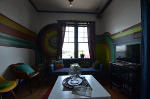 a living room with colorful walls and a window at Amazing 3 Bedroom Apt! 11 Beds! in Providence